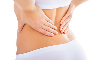 A woman with Sciatic and back pain having acupuncture, massage therapy, and osteopathy in Kelowna.